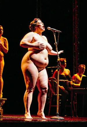 A naked fat singer lady on stage with emotion, captivated audience with her voice and passion