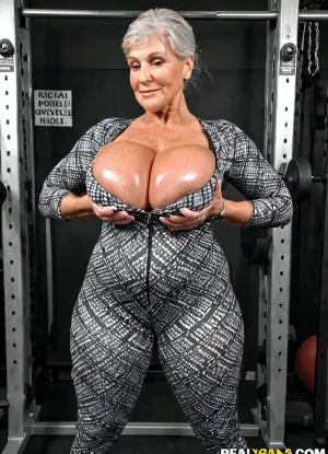 Very busty 60 years old thick grandmother with oversized massive siliconed boobs, real grandmother, casual granny style, too tight patterned spandex suit, bodybuilder poses, training, huge round ass