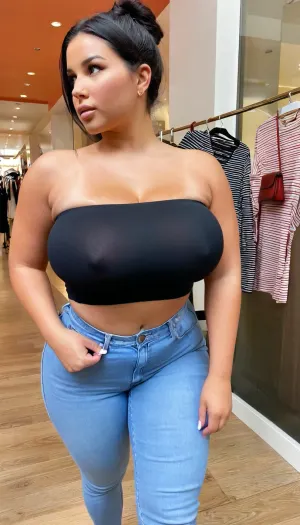 wide shot, high angle, side view, Ultra realistic, realistic skin details, soft smooth skin, 19 yo. latina influencer, very tan, eye liner, walking at an indoor mall in america, xxl sagging long full boobs, huge boobs, maximum cleavage, wearing a black tube top, thin strapless long crop top, high waisted jeans fully on and buttoned, holding a small purse, black hair, looking away, averted gaze, jewelry, pudgy tummy, ((fully dressed:1.2)), braless, Wearing, clothes, that, make, sense, with, Braless>, <lora:clothed_small:1.1>, <lora:bralessSDXL_v1_00022:.7>
