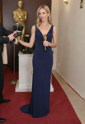 Beautiful celebrity, skinny blonde, 40 years old, Oscar ceremony. Navy blue long dress. In front of the cameras and the media from all over the world, she receives a prize, a big golden plug. Proud, she thanks everyone on the microphone. HD, realistic, 4k, masterpiece