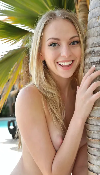 Candid photo, nude 24 year old athletic blonde, slender, on photorealistic Miami public beach, realistic detailed face, long hair, shy laugh, ((peeking around a palm tree)), realistic detailed skin, realistic detailed eyes