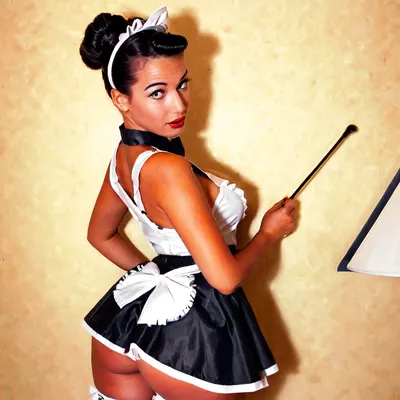 small petite beautiful doe-eyed ebony french maid in traditional french maid uniform with hair in loose bun, ((50s pin-up style)), ((retro period-accurate picture from the 1950s))