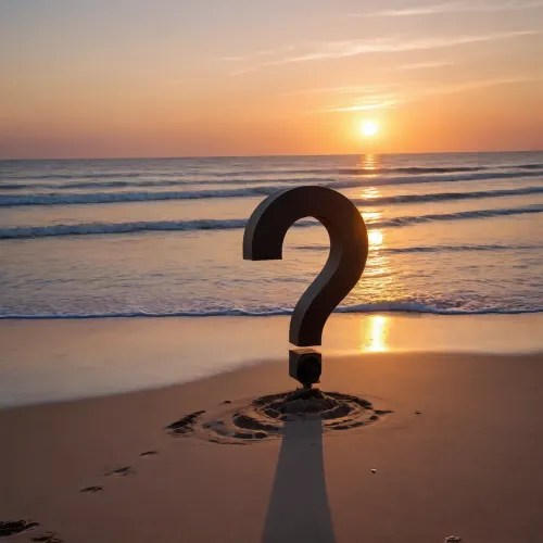 A big steel question mark 10 meters high on a beach in front of a sunset