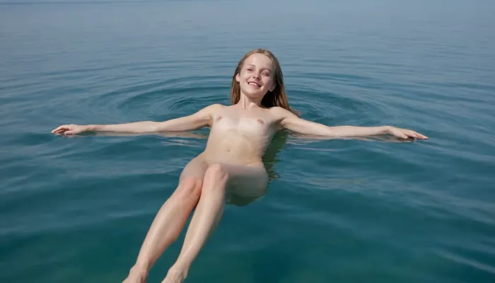 Ukrainian dark ash blonde just thirteen-year-old tiny slender girl, completely nude, hairy pussy, barefoot, happily smiling, swimming serenely on her back full-length in a clear blue sea